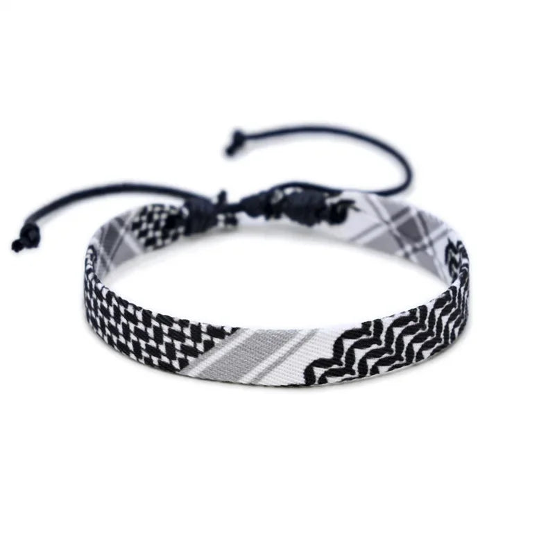 Traditional Black and White 'Tatreez Keffiyeh Hand Woven Bracelets | Tatriz Color Options OSFA Hand-Tied Clasp' option.
