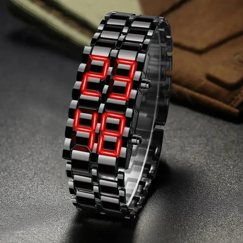 Digital watch with red LED display on a dark surface