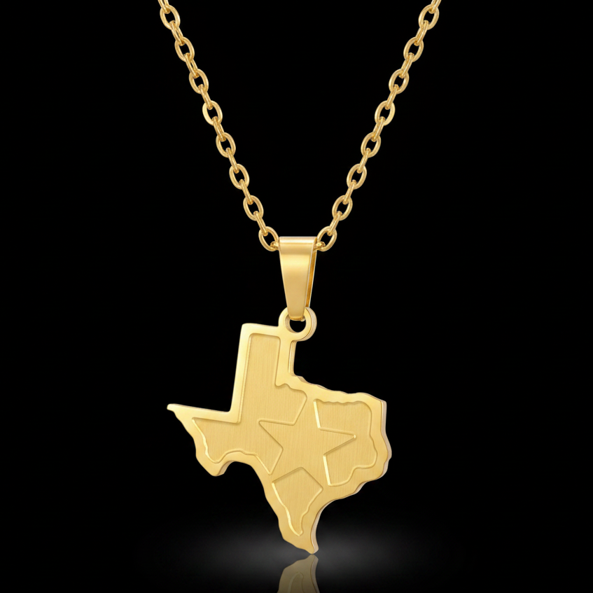 A gold pendant necklace featuring the outline of the state of Texas with an engraved star, suspended from a gold link chain against a solid black background.