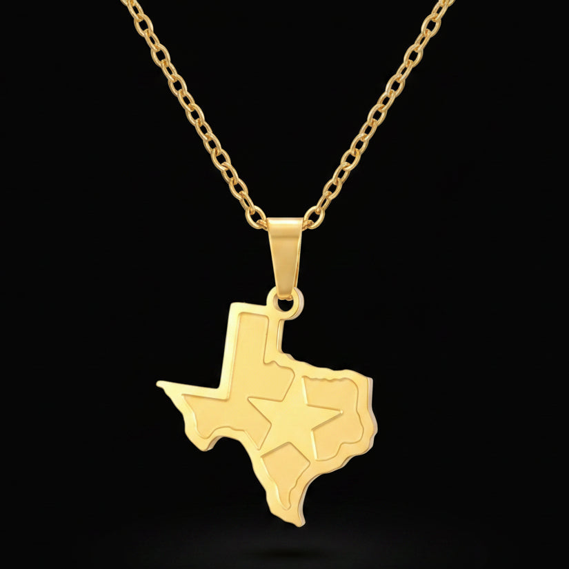 A gold-colored necklace with a pendant in the shape of the state of Texas, featuring a star.