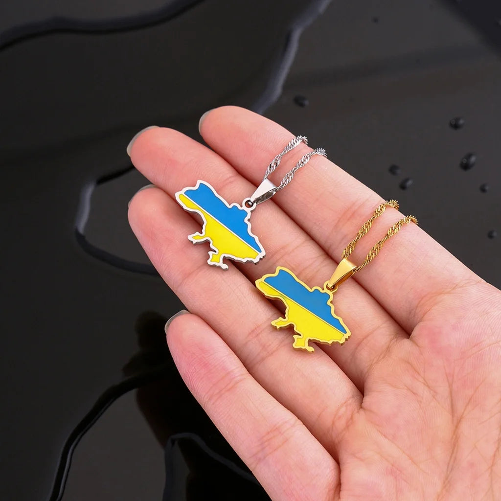 Ukrainian Map Necklace shown in gold and silver options displayed close-up, both in the palm of a hand.