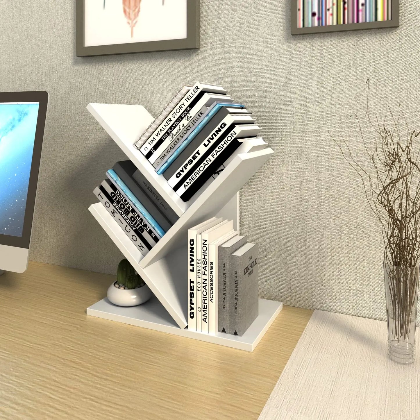 White bookshelf with books on a wooden desk next to a computer monitor.
