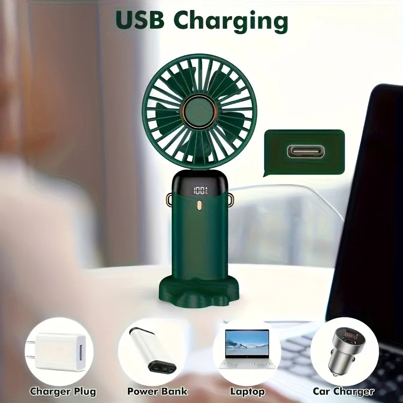 Green USB charging fan with power bank and car charger features on a blurred background