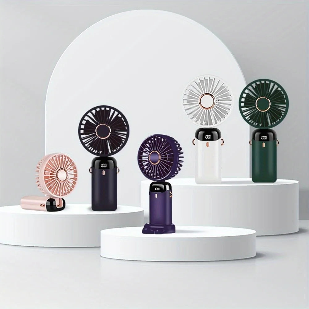 Collection of portable hand fans on a white platform for display.