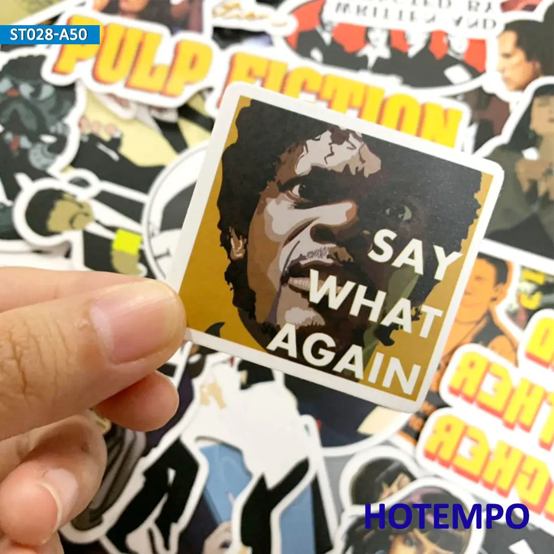 Pulp Fiction decal bundle with sticker with a face and 'Say What Again?' text held by a hand, with other stickers in the background.