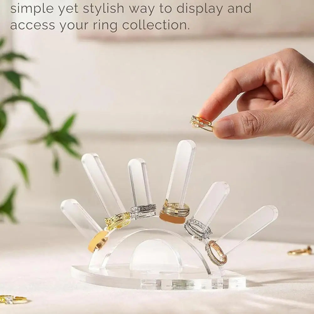 Clear ring holder with multiple rings on a light background