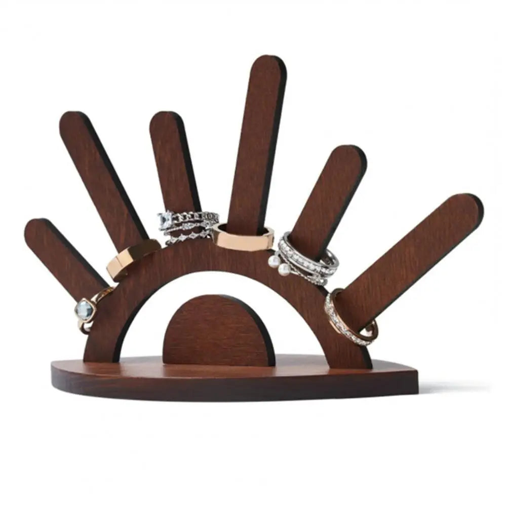 Wooden ring holder with multiple rings on a white background