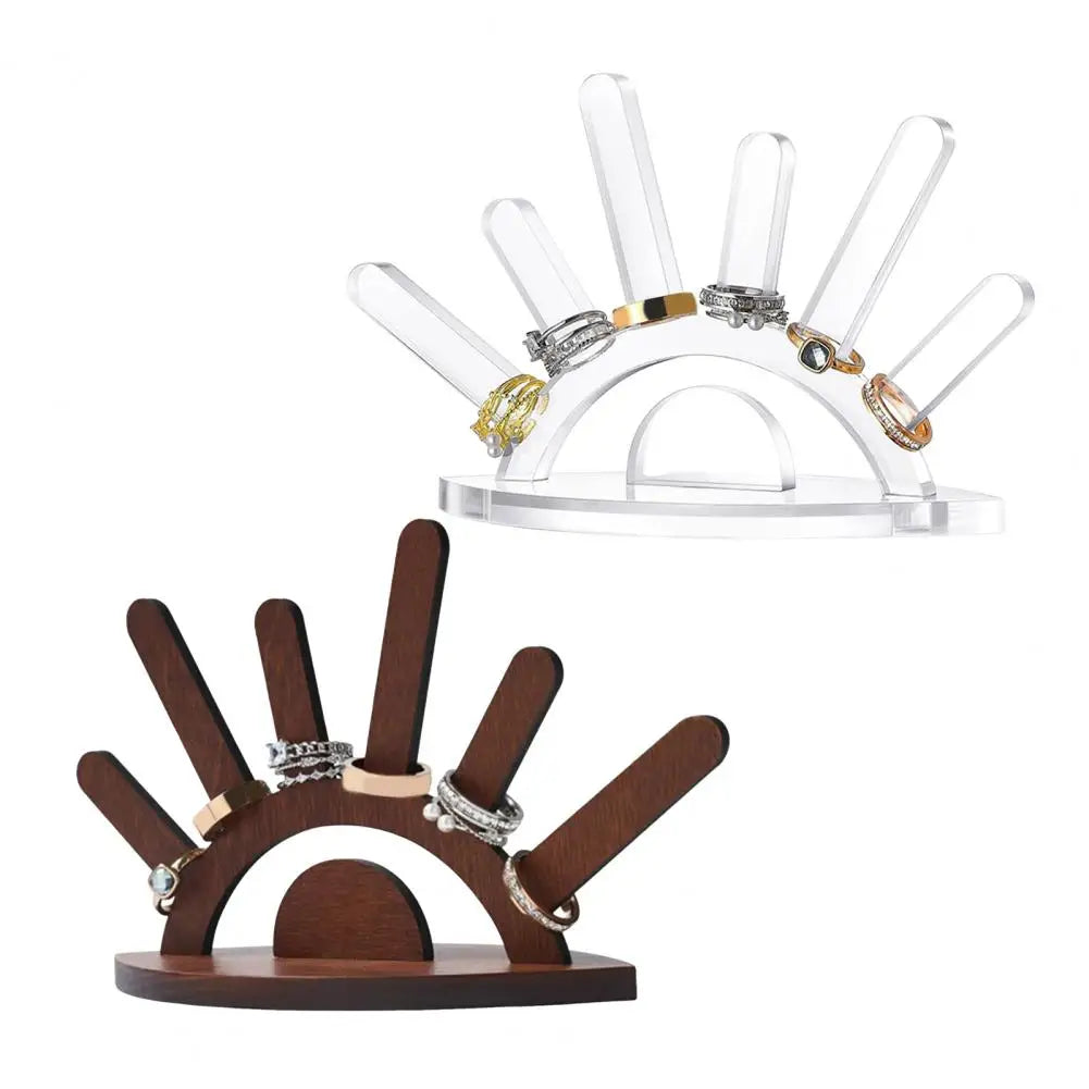 Ring holder with wooden base and clear acrylic top displaying various rings.