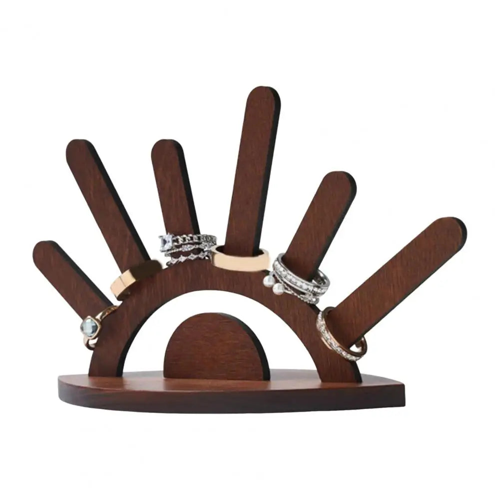 Wooden ring holder with multiple rings on a white background