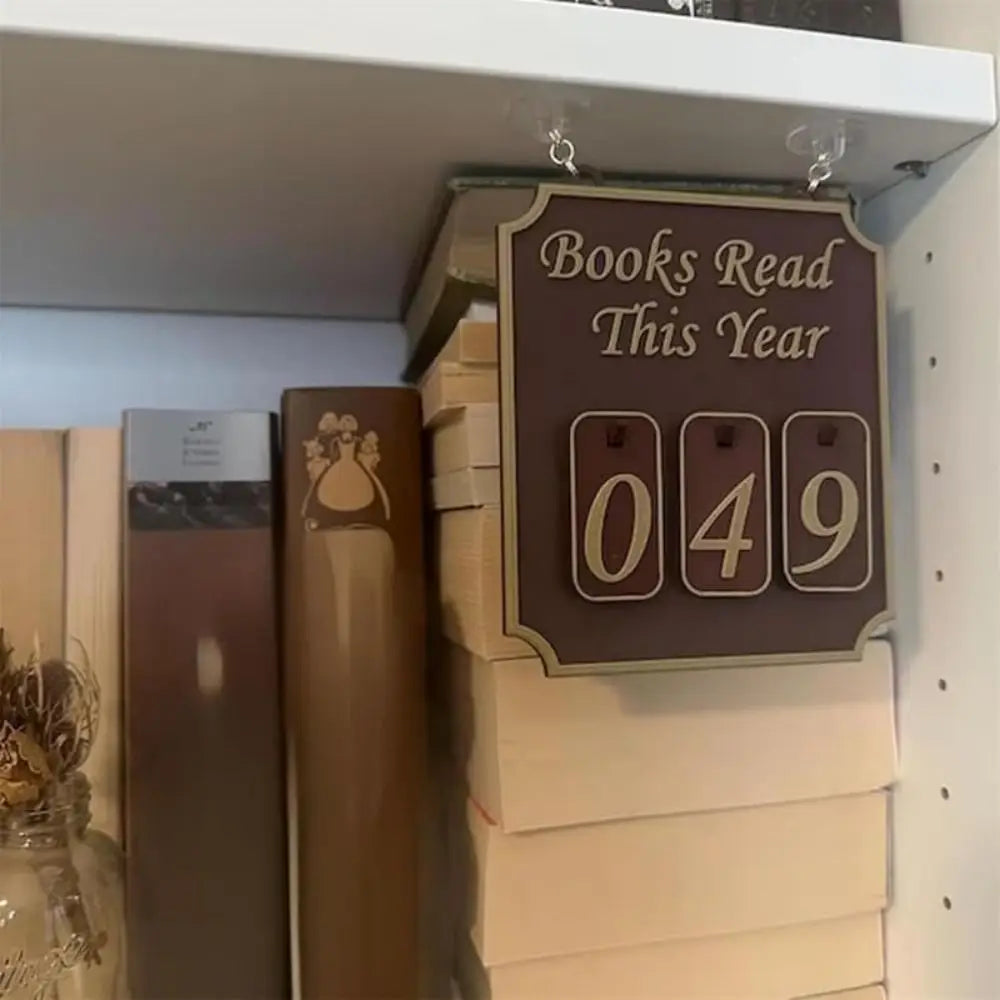 Stack of books with a sign indicating 'Books Read This Year' and the number '049'.