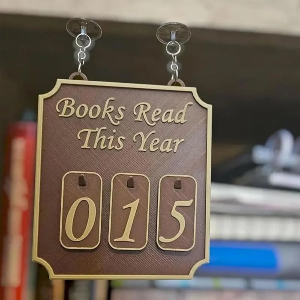 Decorative sign with 'Books Read This Year' and number '015' on a blurred bookshelf background.