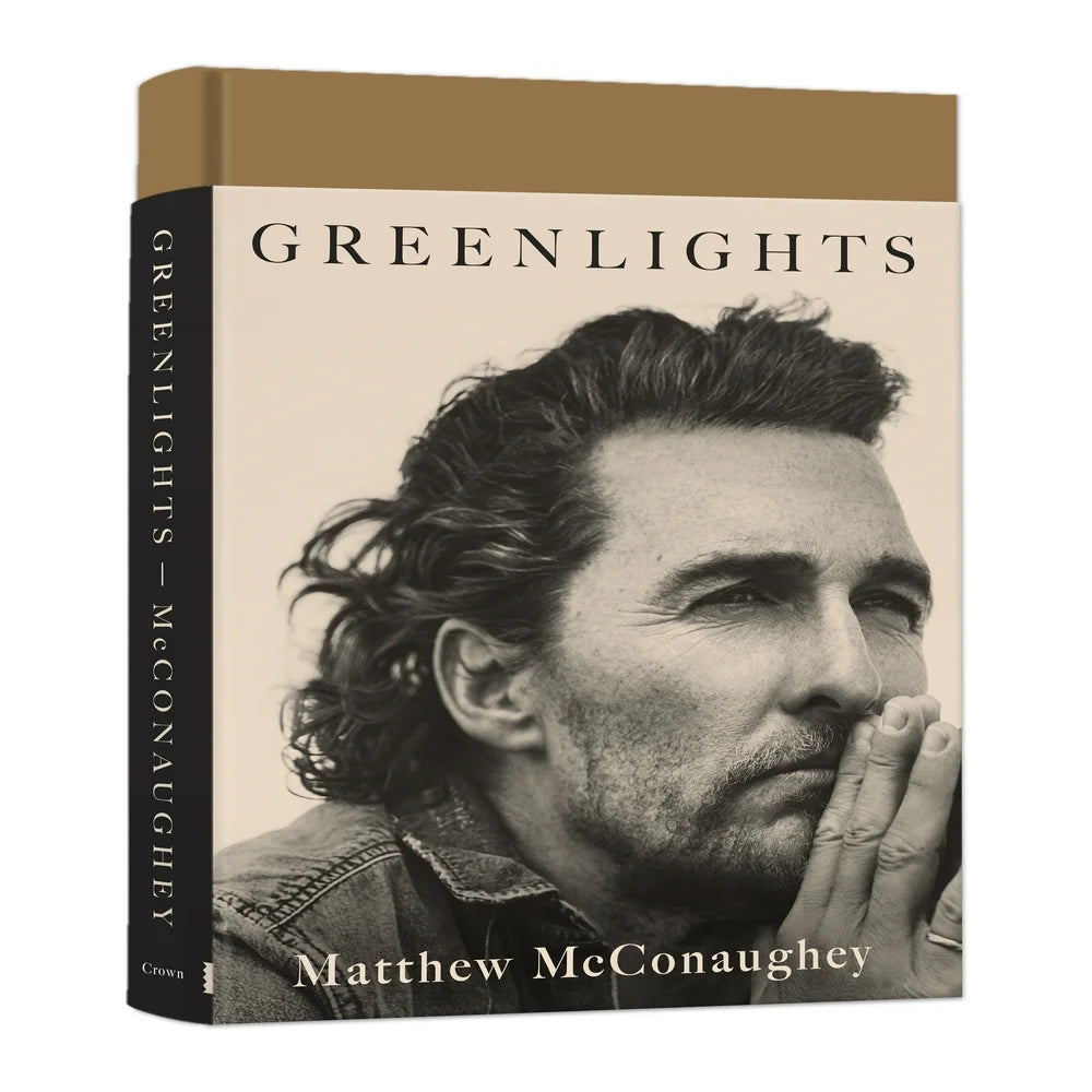Hardcover book titled 'Greenlights: Raucous Stories and Outlaw Wisdom from the Academy Award-Winning Actor' by Matthew McConaughey, featuring a photograph of the author on the cover.